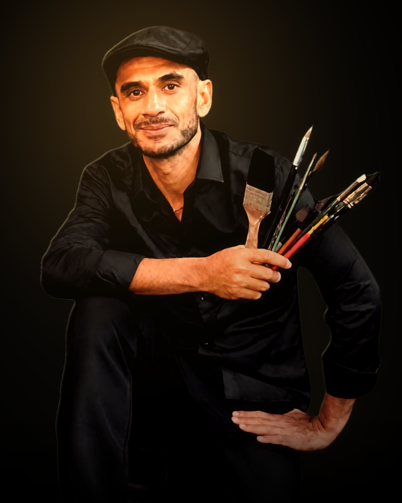Jeffry Feeger seated, dressed in black, holding a fan of paintbrushes.